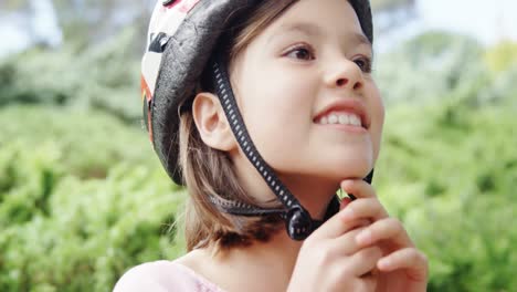 smiling girl wearing helmet in the park