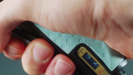 a macro close up shot of a man hand squeezing a arm clamp trainer, 4k video, fitness sport