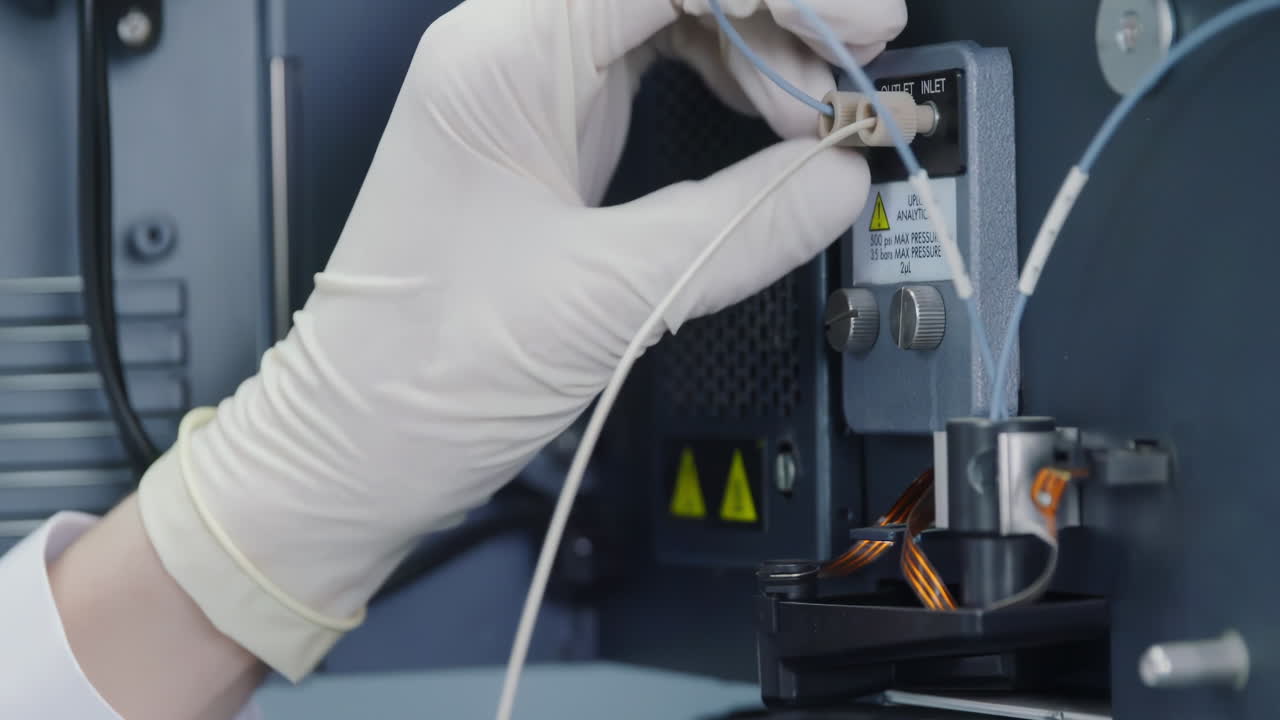 Advanced biochemistry where scientists or technicians conduct a series of tests on a chemical analyzer in a biological laboratory