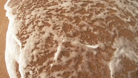 sun lettering on the sand washes away the sea water on the sunny day.