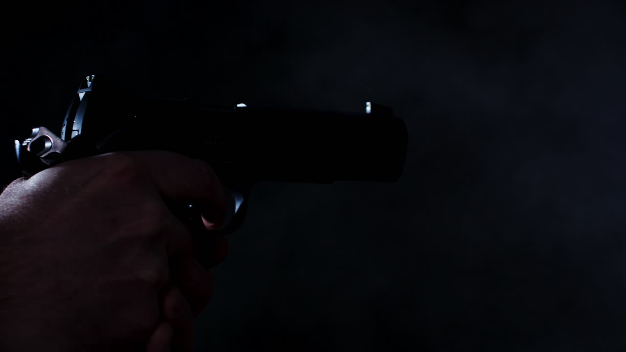 Handgun shooting multiple times in a dark room