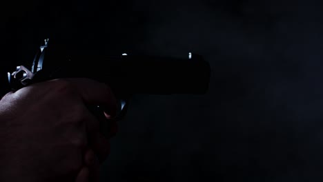 handgun shooting multiple times in a dark room