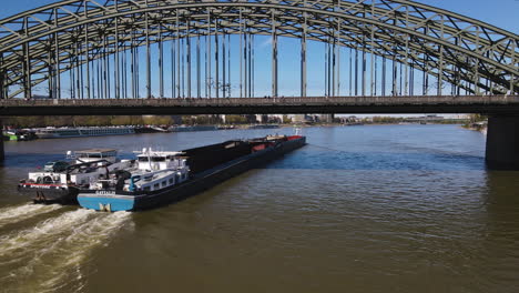 aerial tracking cargo boat going under hohenzollern bridge cologne germany