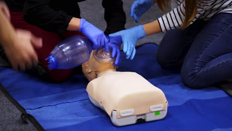 first medical help training equipment. medical dummy lays on blanket . practititoner puts oxygen mask. educational courses for medics.