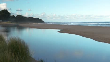 serene beach scene with stunning reflections shimmering off calm water