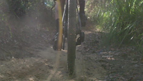 sand flies of backwheel in slowmotion as rider pedals uphill