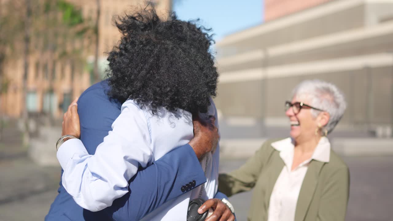 Business people shaking hands and embracing in the financial district