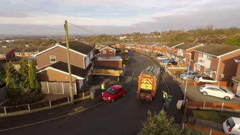 Aerial-View-of-Dustmen-putting-recycling-waste-into-a-waste-truck,-Bin-Men,-Recycling-day,-refuse-collection-in-Stoke-on-Trent,-Staffordshire