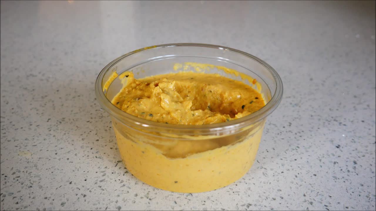 Houmous dip. Pitta bread dipped and eaten.