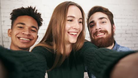 portrait of smiling casual business team taking selfies in the office. creative diverse business team in modern office pose for