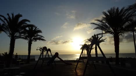 children playground in front of the beach at sunrise time