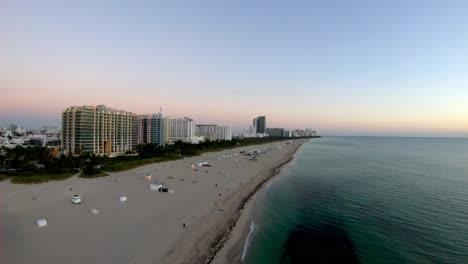 aerial drone footage of miami beach at sunrise including the beach front and the buildings