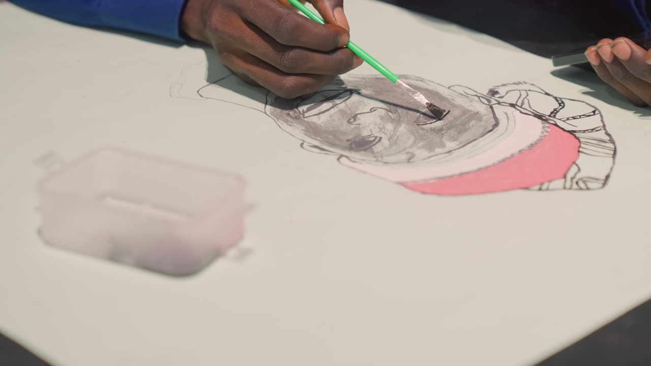 Student sketches portrait. Painter utilizes green brushstroke. Classroom scene depicts attentive student creating art. Art student employs lively brush and water container during class session
