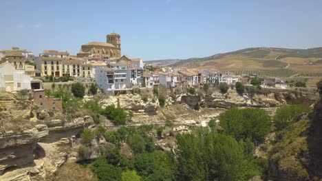 aerial view of white houses on the edge of a canyon in the town of alhama de granada, andalusia, spain