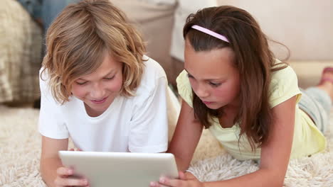 siblings using a tablet computer