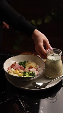 woman serving cold russian soup (okroshka)