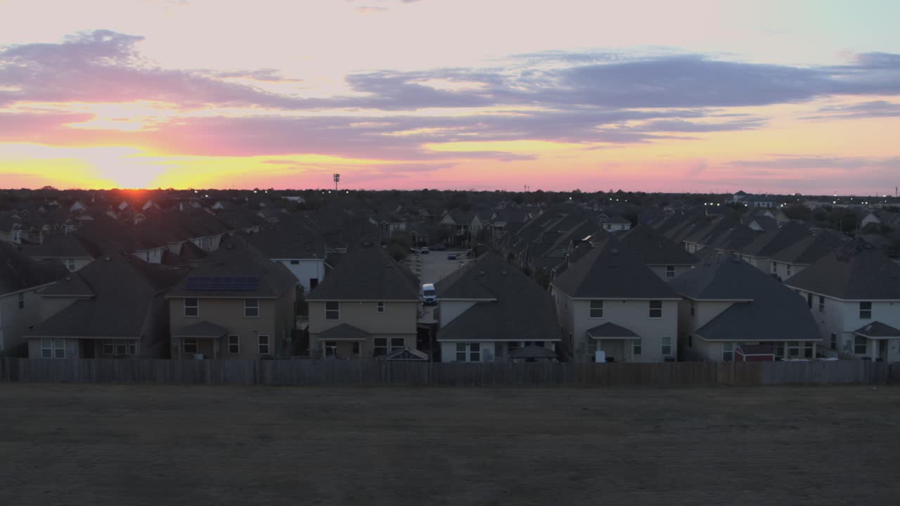 Smooth aerial drone footage of the Mission Bend residential neighborhood in west Houston, Texas, showing suburban homes and community layout during sunset