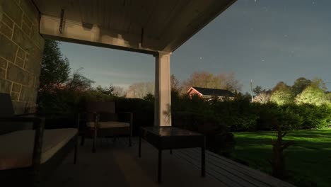 house porch view of stars moving through night sky, tilting timelapse