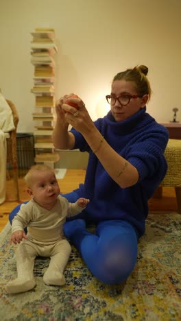 mother feeding baby an apple