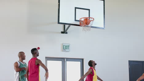 young african american men enjoy a game of basketball indoors