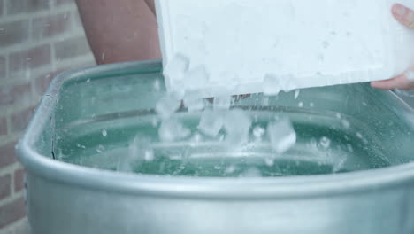 Pouring-Box-Of-Ice-Cubes-Into-Ice-Bath-Tub