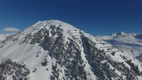 Aerial-view-of-a-snowy-mountain-discovering-the-french-alps-and-the-Mont-Blanc.