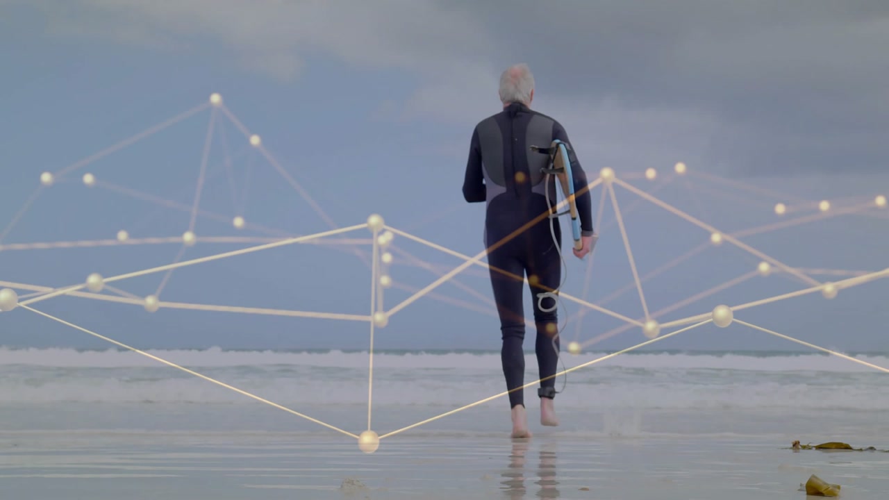 Male surfer seeing surf, running to sea with board to surf, glowing nodes overlay tech