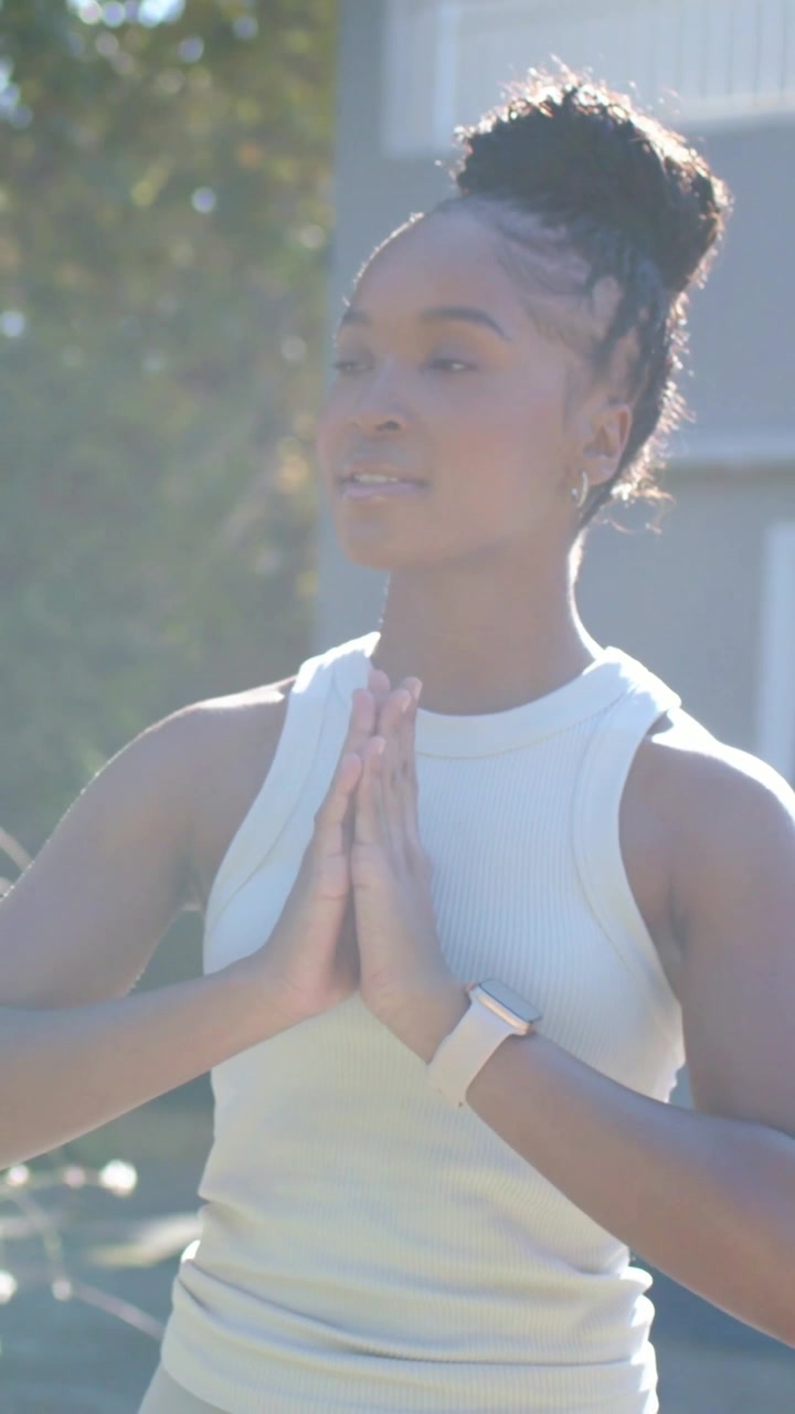 Vertical video: Reacting to hand woman clapping holding palms at chest outside home white tank top