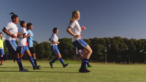 Female-soccer-team-running-while-team-captain-gives-instructions.-4k