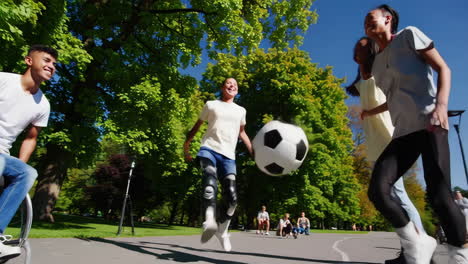 young people playing inclusive soccer in a park