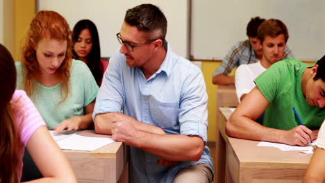 lecturer helping a student in classroom