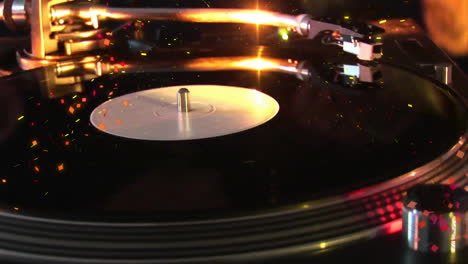 animation of confetti, record player and spot lights on black background