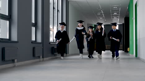 Group-Of-Happy--Preschool-Students-In-Mortarboard-And-Gown-4