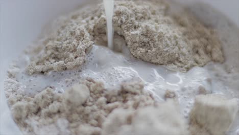 adding milk in an oatmeal biscuits blended mixture