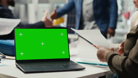 businesspeople in office do financial investments, looking at chroma key laptop