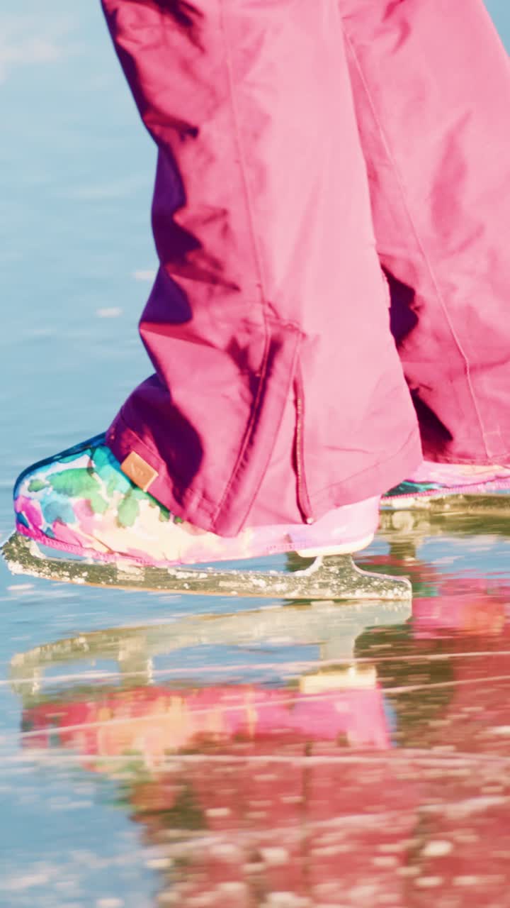 Graceful Ice Skating on a Beautiful Surface: A Close-Up View of a Skater's Colorful Footwear Gliding Over the Smooth Ice with Reflections Captured in the Moment