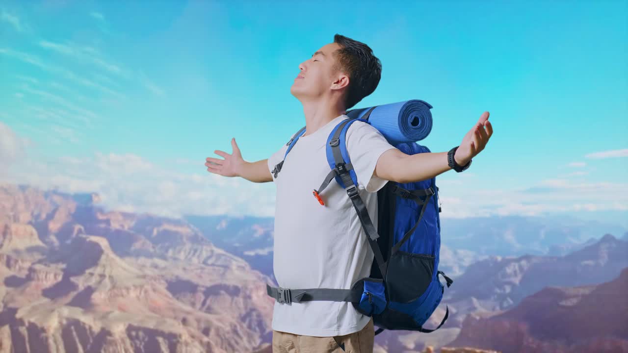 Side View Of Asian Male Hiker With Mountaineering Backpack Smiling And Spreading Arms Enjoy Looking The View Around While Traveling At The Top Of Mountain