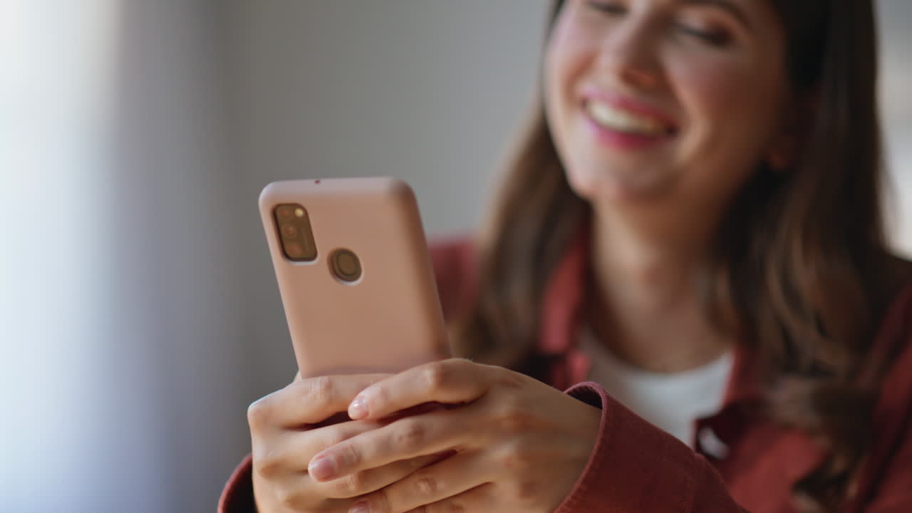 Housewife touching cellphone screen at home closeup. Woman watching funny video
