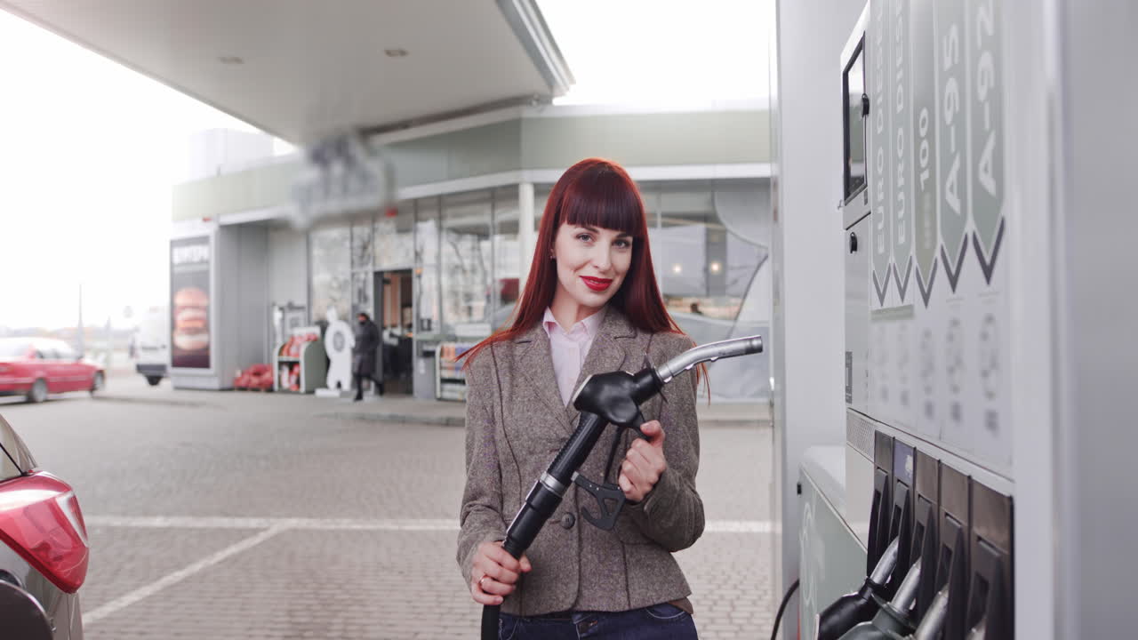 Woman refueling her car at a gas station