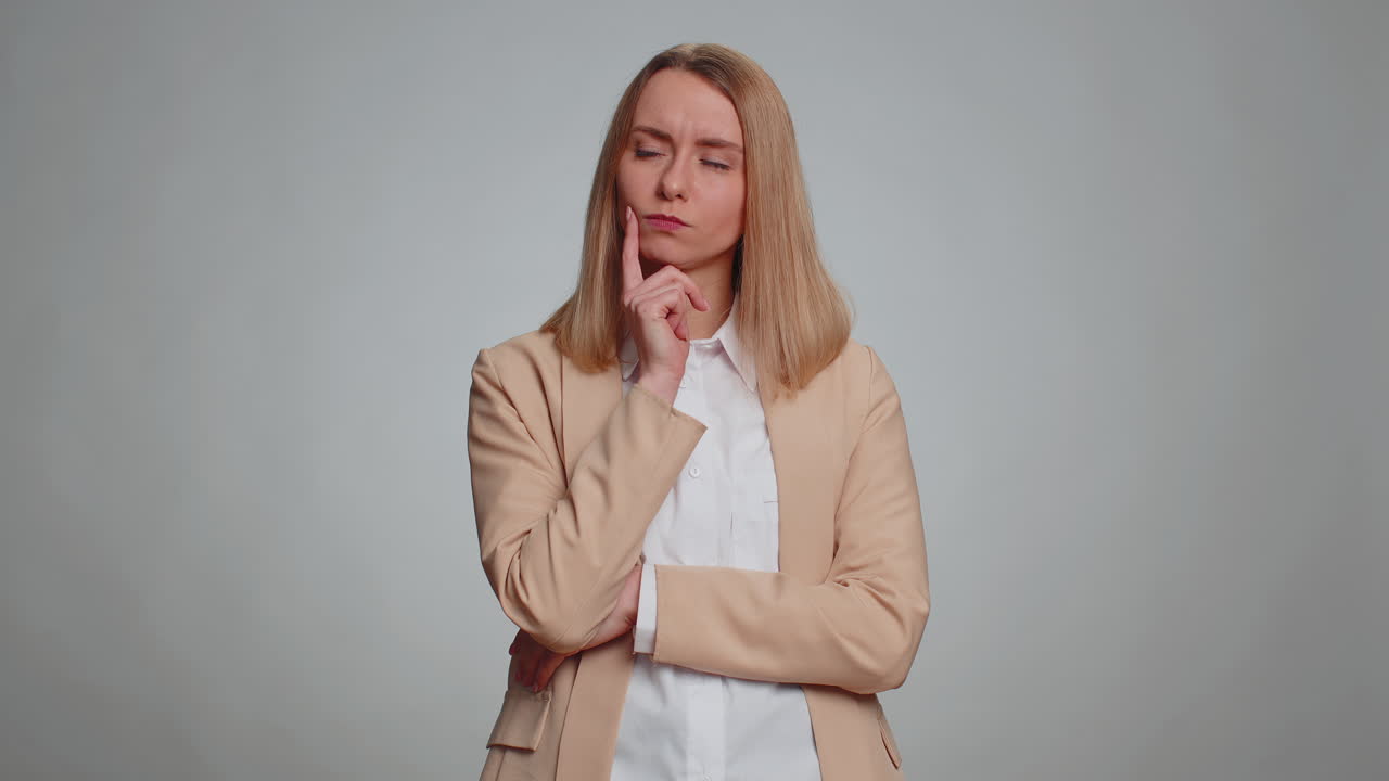 Thoughtful clever woman rubbing chin pondering a solution doubting question pensive expression