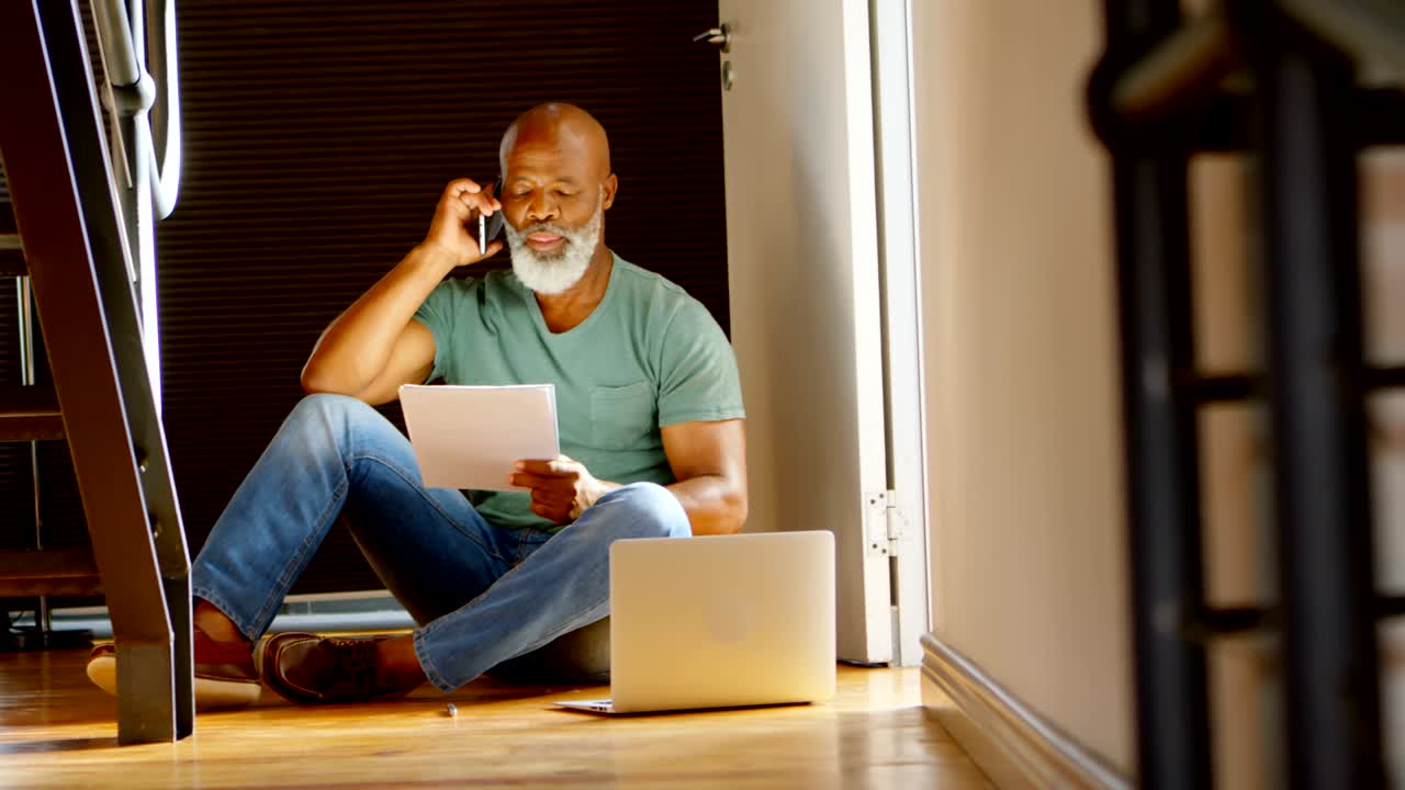 Senior man talking on mobile phone at home 4k