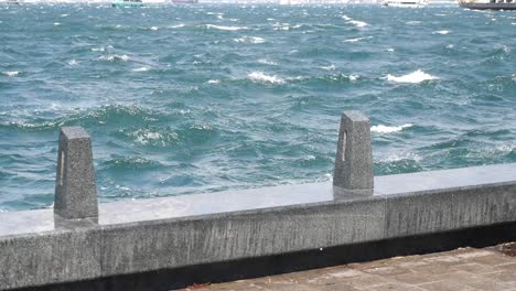 choppy water and granite promenade on a windy day