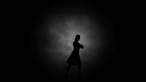 A-modern-youth-dance-performed-by-a-graceful-and-sexy-female-silhouette,-in-the-smoke-against-the-backdrop-of-spotlights