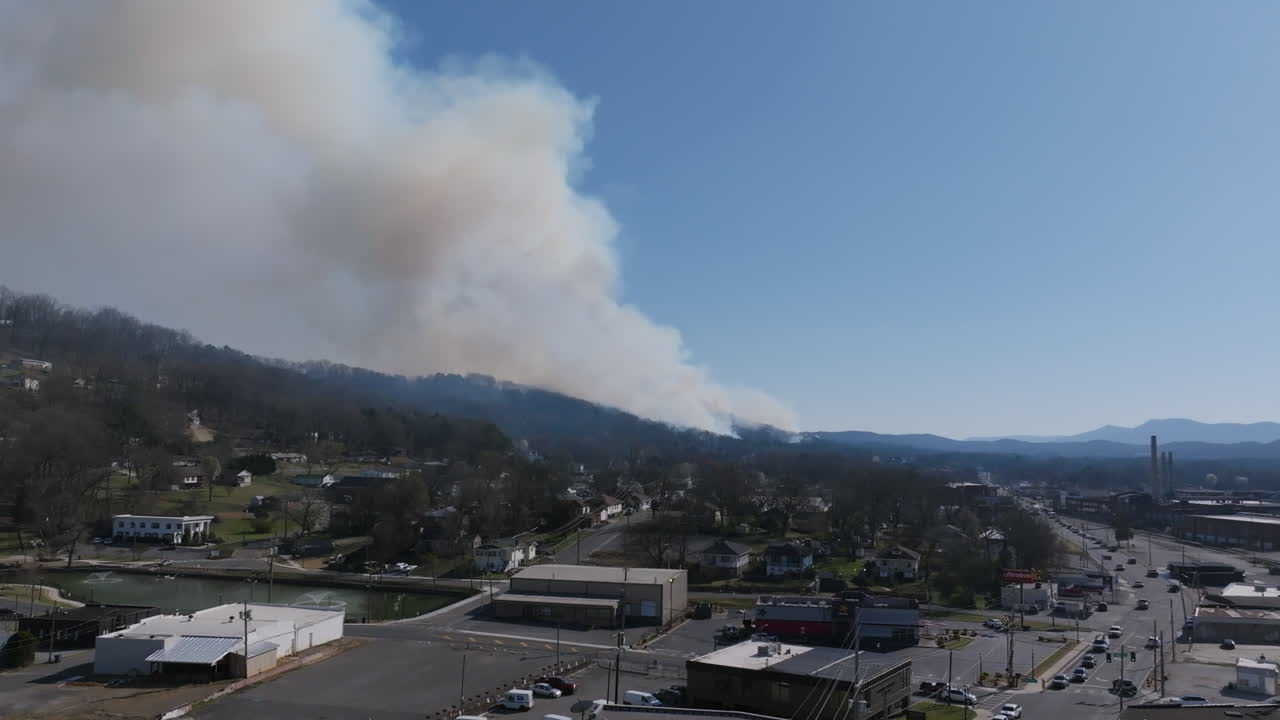 Aerial drone footage that is close to the streets with a view of a large forest fire in Rossville, Georgia.