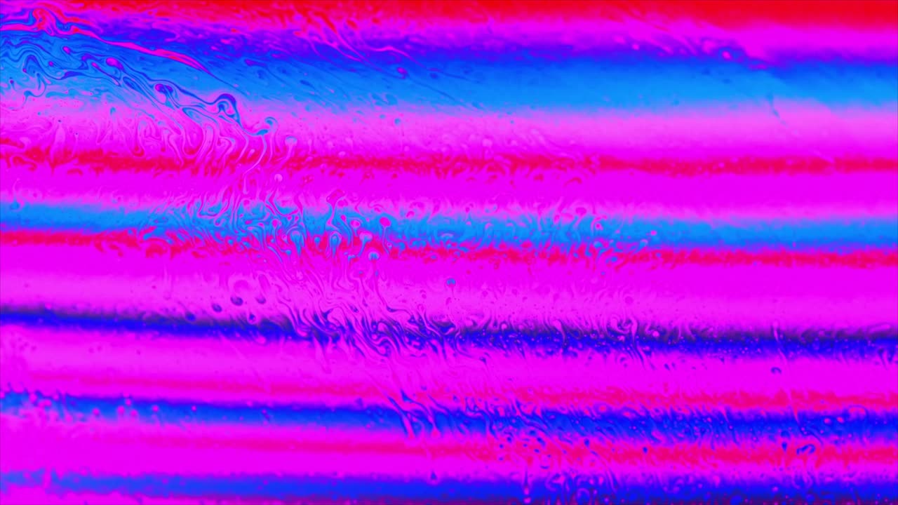 Macro View of Iridescent Soap Film with Vibrant Pink and Blue Colors