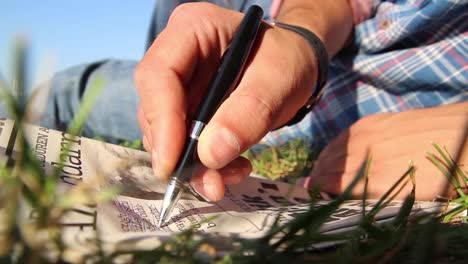 Young-Man-Reading-Newspaper-With-Pencil