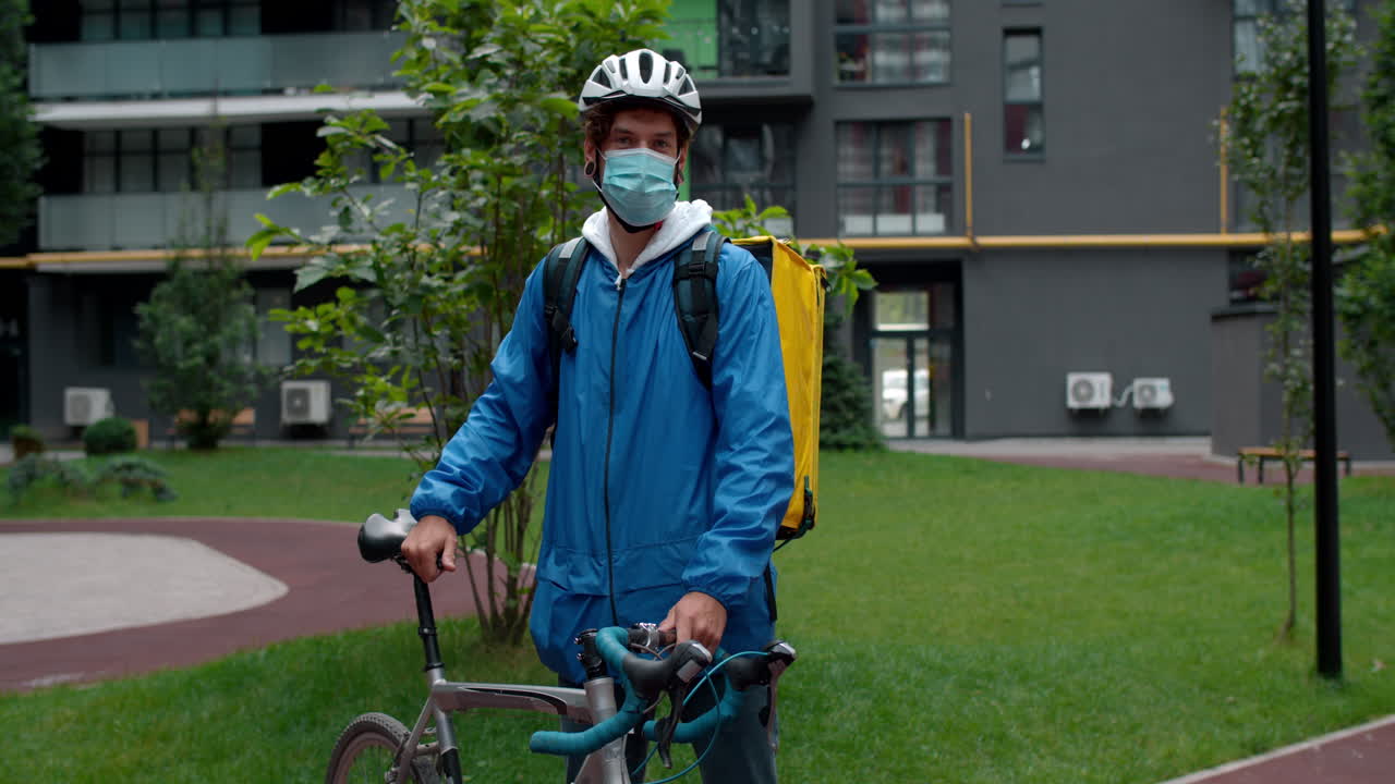 Delivery person with bicycle and face mask