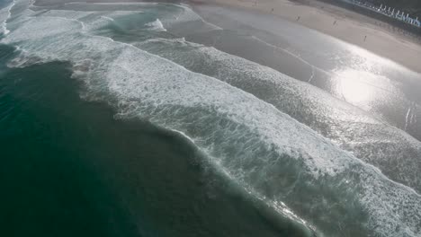 high aerial perspective of rolling waves spread across sintra portugal beach