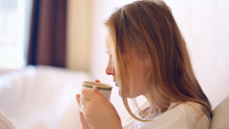 woman having a cup of hot coffee in the morning