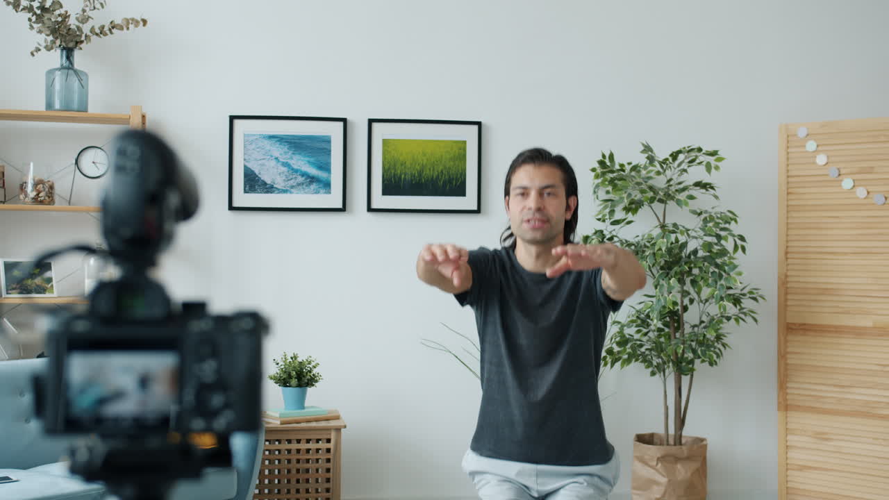 Man Doing Yoga Tutorial in His Living Room